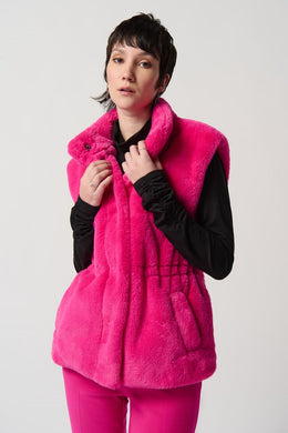 Fully lined with pockets and an adjustable elastic waistband, this faux-fur vest will add a layer of warmth to any outfit with a touch of sophistication. Whether you style it over a button-down or pair it with your go-to knit dress, you're sure to exude confidence and charm in any setting.   Color-Shocking pink. Faux fur. Mock neck. Sleeveless. Front closure with snaps. Lined.