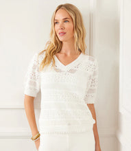 Load image into Gallery viewer, Woman wearing an off-white, short sleeve crochet top against a white background.
