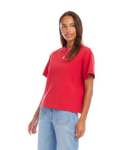 Load image into Gallery viewer, Woman wearing a red short sleeve top and light blue jeans on a white background.
