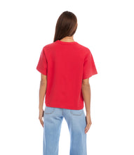 Load image into Gallery viewer, Woman wearing a red short sleeve top and light blue jeans on a white background.
