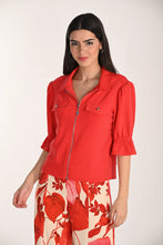 Load image into Gallery viewer, Woman wearing a red short sleeve zipper front top and floral pants on a white background.
