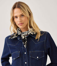 Load image into Gallery viewer, A woman wearing a dark blue denim western-style jacket with a black and white patterned bandana tied around her neck, photographed against a light gray studio background.

