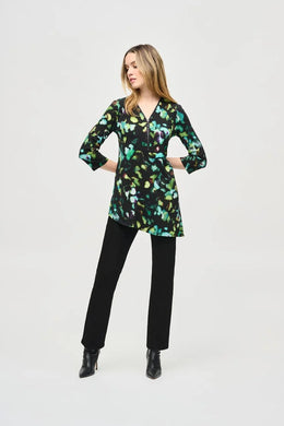 Elegance and comfort blend harmoniously in this beautiful silky knit tunic. Boasting a bold abstract print, the garment is tailored with chic three-quarter sleeves and an airy asymmetrical silhouette that creates an alluring look. The V-shaped neckline with zipper closure infuses modern flair into this classic design.