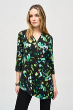 Load image into Gallery viewer, Elegance and comfort blend harmoniously in this beautiful silky knit tunic. Boasting a bold abstract print, the garment is tailored with chic three-quarter sleeves and an airy asymmetrical silhouette that creates an alluring look. The V-shaped neckline with zipper closure infuses modern flair into this classic design.
