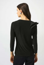 Load image into Gallery viewer, Woman wearing a black top with ruffle and black pants against a white background.
