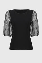 Load image into Gallery viewer, This sleek, fitted knit top is given a romantic flair with puff mesh sleeves adorned with delicate pearls. It&#39;s the perfect choice for an enchanting date night or a glamorous occasion.
