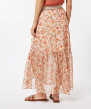 Load image into Gallery viewer, A beautiful skirt that easily transitions from the warmer to cooler months, our Taylin offers a beautiful abstract floral print in orange, brown and red against a pale peach background. Gold threading throughout and a shiny gold elastic waist band adds elegant features. The Taylin has the look of a wrap skirt but is connected for easy wear, with a ruffle running down one side of the split skirt in the front.  Fully lined in beige color to the knee with a transparent look at the bottom. 
