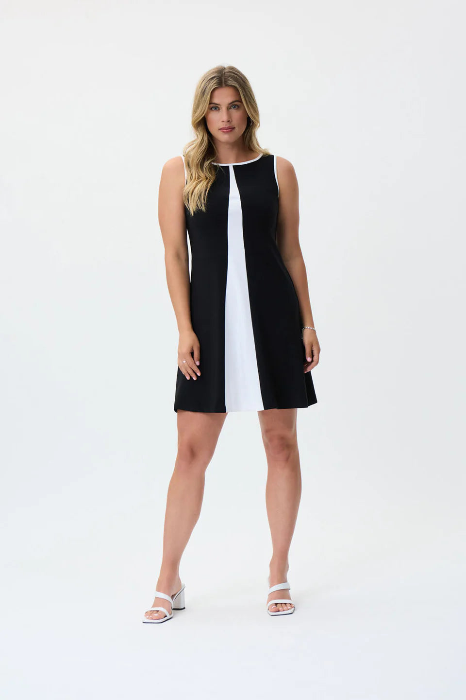 Make a statement with the Joseph Ribkoff Black and Vanilla Dress, designed for effortless elegance. This sleeveless, knee-length dress features a modern color-blocked design, perfect for both formal events and casual outings. Crafted from soft ITY fabric, it offers a comfortable stretch fit that moves with you. Designed for versatility, the Black/Vanilla color combination creates a striking contrast, making it perfect for both daytime chic and evening elegance. 