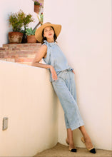 Load image into Gallery viewer, Timelessly chic, this powder wash blue sleeveless blouse features a flattering bow-tie neck, perfect for adding sophistication to any outfit. Whether you're dressing up for a day at the office or a night out, this elegant piece offers effortless style.
