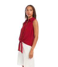 Load image into Gallery viewer, Woman wearing a red sleeveless blouse with a tie front and white shorts on a white background.
