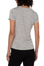 Load image into Gallery viewer, Woman wearing a tan and black stripe short sleeve top and black pants against a white background.
