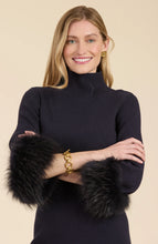 Load image into Gallery viewer, This season, elevate your special occasion wardrobe with the Sloane Fur Trimmed Knit Dress in Black by Tyler Boe. Enhanced with sophistication and glamour, this dress features a chic mock neck and luxurious fur cuffs. Make a statement and stand-out in a crowd with this stunning piece.
