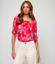 Load image into Gallery viewer, This square neck top is made from soft viscose fabric and features a delicate floral pattern that adds a touch of romance to your ensemble. It is suitable for both casual and special occasions, with short ruffled sleeves adding a playful and feminine touch. The fabric&#39;s softness also creates a pleasant movement with every step taken.
