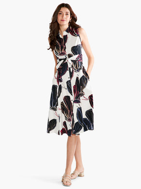 A classic and timeless design, our Sydney dress expertly combines black, white, and just the right amount of color in an oversized floral print. The silhouette is sleeveless and designed to fall below the knee. With pockets, a subtle collar, a sash at the waist this gorgeous dress is designed to flatter.   Colors-White, black, blue, pink, beige. Woven dress. Shirt dress. Button front. Shirt collar. Sleeveless. Falls below knee.