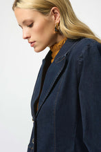 Load image into Gallery viewer, Woman wearing an indigo denim jacket over a yellow top against a white background.
