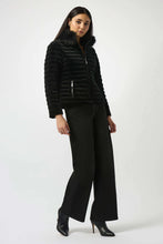 Load image into Gallery viewer, Woman modeling a black quilted jacket with fur collar, black pants and black boots against a white background.
