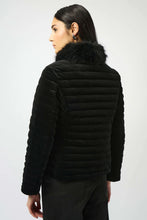 Load image into Gallery viewer, Woman modeling a black jacket with faux fur collar and black jeans against a white background.
