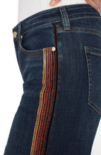 Load image into Gallery viewer, Close-up of dark blue jeans with a brown multicolor striped detail against a white background.
