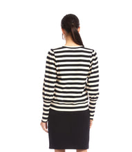 Load image into Gallery viewer, Woman wearing a black and cream striped top with a black leather skirt  against a white background.
