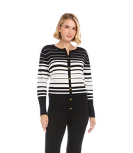 Load image into Gallery viewer, Woman wearing a black and off-white striped cardigan sweater and black pants against a white background.
