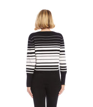 Load image into Gallery viewer, Woman wearing a black and off-white striped cardigan sweater and black pants against a white background.
