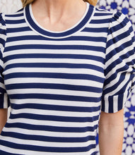 Load image into Gallery viewer, Navy and white striped shirt worn by a person with a blurred background.
