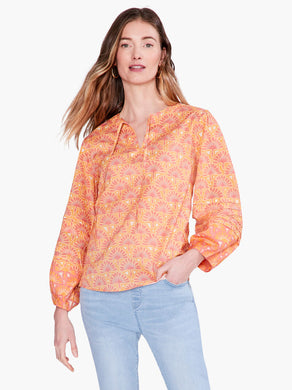 This bright and festive shirt takes your next casual look in an all-new direction. Tie the front to make a keyhole opening or leave it open. The design includes bracelet cuffs and flowy bishop sleeves. Sits just below the waist in an easy fitting silhouette.   Color-Orange multi. Easy fit. Round neck. Bracelet sleeve. Bishop sleeve.