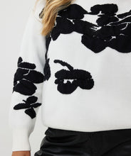 Load image into Gallery viewer, Receive compliments when you style this gorgeous EsQualo sweater with 3D flowers in a classic black and off-white color. Crafted from a blend of viscose, nylon, and polyester, this sweater not only offers a luxurious feel but also ensures durability and breathability. The intricate 3D flower embellishments add a unique touch, making it a standout piece in any wardrobe. Perfect for layering over jeans or pairing with a skirt for a sophisticated look.
