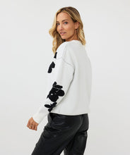 Load image into Gallery viewer, Receive compliments when you style this gorgeous EsQualo sweater with 3D flowers in a classic black and off-white color. Crafted from a blend of viscose, nylon, and polyester, this sweater not only offers a luxurious feel but also ensures durability and breathability. The intricate 3D flower embellishments add a unique touch, making it a standout piece in any wardrobe. Perfect for layering over jeans or pairing with a skirt for a sophisticated look.
