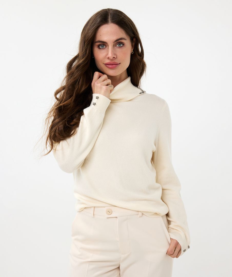 Elevate your wardrobe with the EsQualo Embellished Gem Collar Sweater. This stunning piece features a split turtleneck adorned with gem embellishments on both sides of the split collar, adding a touch of elegance and sophistication to your look. The sweater is designed with long sleeves, two floral gems on each cuff and a comfortable fit, making it perfect for both casual and dressy occasions.