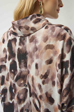 Load image into Gallery viewer, Woman wearing an off-white and brown multi animal print tunic sweater with buttons down the back against a white background.
