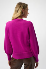 Load image into Gallery viewer, Woman wearing a purple cardigan with rhinestone buttons and brown faux leather pants against a white background.
