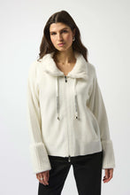 Load image into Gallery viewer, Woman wearing a Winter white zip-up coat with a fur-lined collar and cuffs and black pants against a white background.
