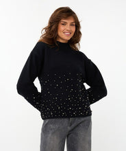 Load image into Gallery viewer, Woman wearing a black sweater with  black pearls on lower half of sweater and sleeves and grey pants against a white background.
