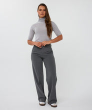 Load image into Gallery viewer, Woman wearing a grey short sleeve turtleneck sweater, grey wide-leg pants and white shoes against a white background.
