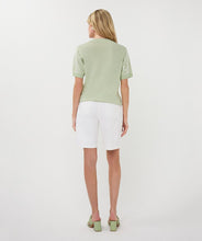 Load image into Gallery viewer, Woman wearing a light green sequin top, white shorts and light green sandals on a white background.
