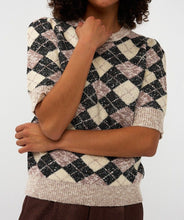 Load image into Gallery viewer, Woman wearing a short sleeve argyle sweater and brown pants against a white backdrop.
