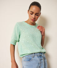 Load image into Gallery viewer, Woman wearing a light mint green short sleeve sequin sweater and blue jeans on a white background.

