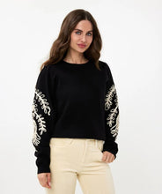 Load image into Gallery viewer, Our Sanne sweater is a work of art and a masterpiece of comfort and style. This black sweater features elegant puff sleeves and intricate cream stitching details. Crafted with anti-pilling acrylic, it promises durability and superior quality.
