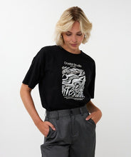 Load image into Gallery viewer, Model wearing a black t-shirt with sequins and text and grey pants against a white background.
