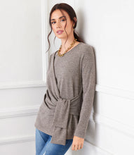 Load image into Gallery viewer, This top stands out from the rest with a drape front detail designed to flatter the waist. Constructed from a soft, brushed-knit material, it can be dressed up or worn casually. A beautiful heathered taupe hue ensures effortless style coordination with many of your wardrobe staples.  Color- Heathered taupe. Long sleeve. Crew neck. Pull over. Fabric -81% Polyester. 16% Rayon. 3% Spandex.
