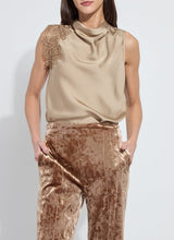 Load image into Gallery viewer, Woman wearing a beige sleeveless top with lace details and brown velvet pants against a white background.
