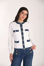 Load image into Gallery viewer, Woman wearing a white and blue cardigan with gold buttons and blue jeans against a white background.
