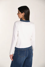 Load image into Gallery viewer, Woman wearing a white and blue cardigan and blue jeans against a white background.
