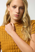 Load image into Gallery viewer, Woman wearing a golden mustard yellow textured top against a white background.
