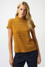 Load image into Gallery viewer, Woman wearing a golden mustard yellow textured top and jeans against a white background.
