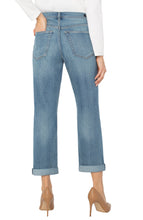 Load image into Gallery viewer, Model wearing white long top, light blue cuffed jeans and beige heels against a white background.
