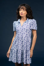 Load image into Gallery viewer, Classic, clean, and effortlessly chic—the Navy Dress by Smith &amp; Quinn is a timeless staple reimagined in the charming Bluebonnet print. This sleeveless silhouette features a tailored bodice, flattering V-neckline, and gently flared skirt that moves with ease. Crafted from Smith &amp; Quinn’s signature stretch fabric, it offers wrinkle resistance and breathable comfort, making it ideal for warm-weather occasions or polished everyday wear.
