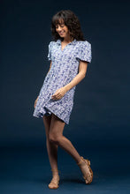 Load image into Gallery viewer, Classic, clean, and effortlessly chic—the Navy Dress by Smith &amp; Quinn is a timeless staple reimagined in the charming Bluebonnet print. This sleeveless silhouette features a tailored bodice, flattering V-neckline, and gently flared skirt that moves with ease. Crafted from Smith &amp; Quinn’s signature stretch fabric, it offers wrinkle resistance and breathable comfort, making it ideal for warm-weather occasions or polished everyday wear.
