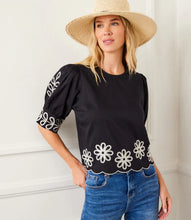 Load image into Gallery viewer, Add a touch of timeless elegance to your wardrobe with the Tesni Three Quarter Sleeve Embroidered Scallop Top by Karen Kane. Featuring delicate floral embroidery, a scalloped hem, and chic puff sleeves, this sophisticated blouse offers a graceful yet modern look for any occasion. Perfect for brunch, workdays, or an evening out, this lightweight embroidered top pairs effortlessly with jeans, skirts, or tailored pants.
